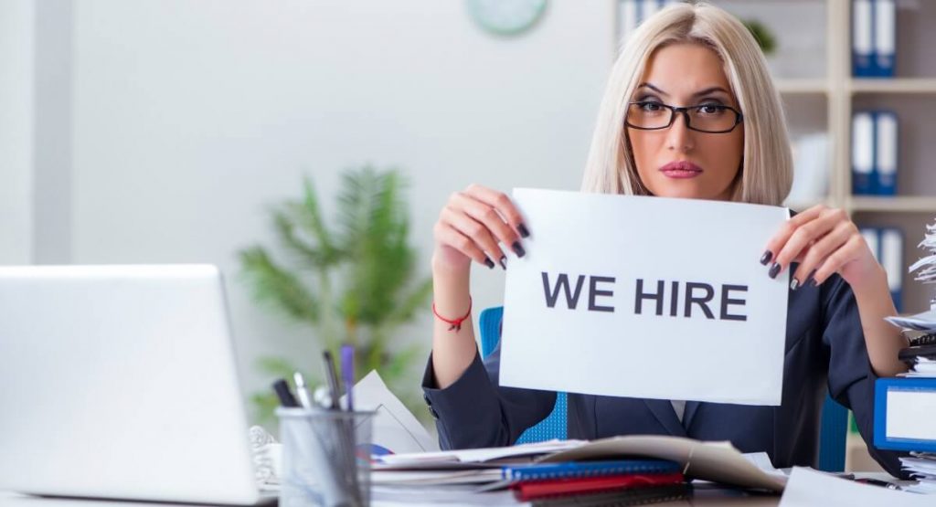 Image showing a recruitment professional with a 'we hire' sign