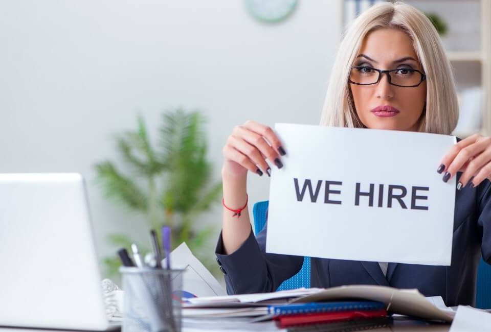 Image showing a recruitment professional with a 'we hire' sign