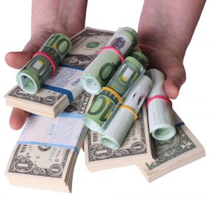 hands-on-money Hands holding cash in multiple currencies depicting cash flow