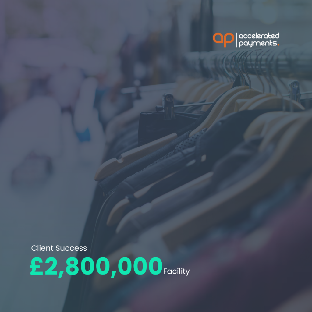 Shop hangers in apparel warehouse with Accelerated Payments logo and “Client Success £2,800,000 Facility” text