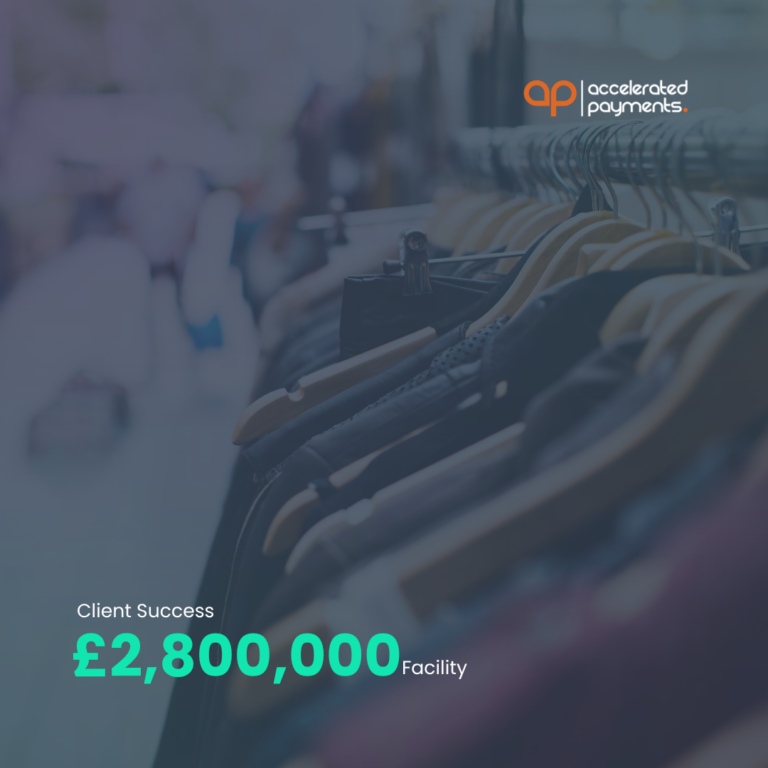 Shop hangers in apparel warehouse with Accelerated Payments logo and “Client Success £2,800,000 Facility” text