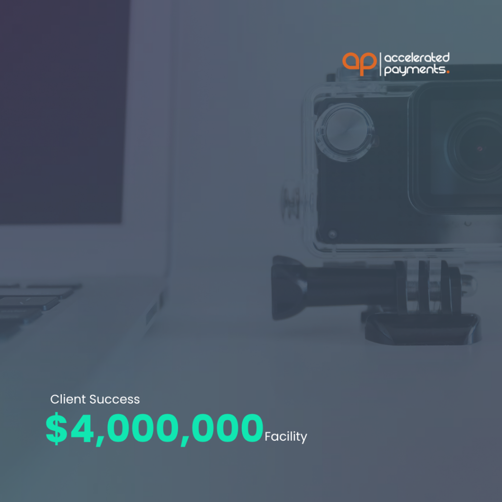 Accelerated Payments logo on office desk with webcam and “Client Success” $4,000,000 facility text